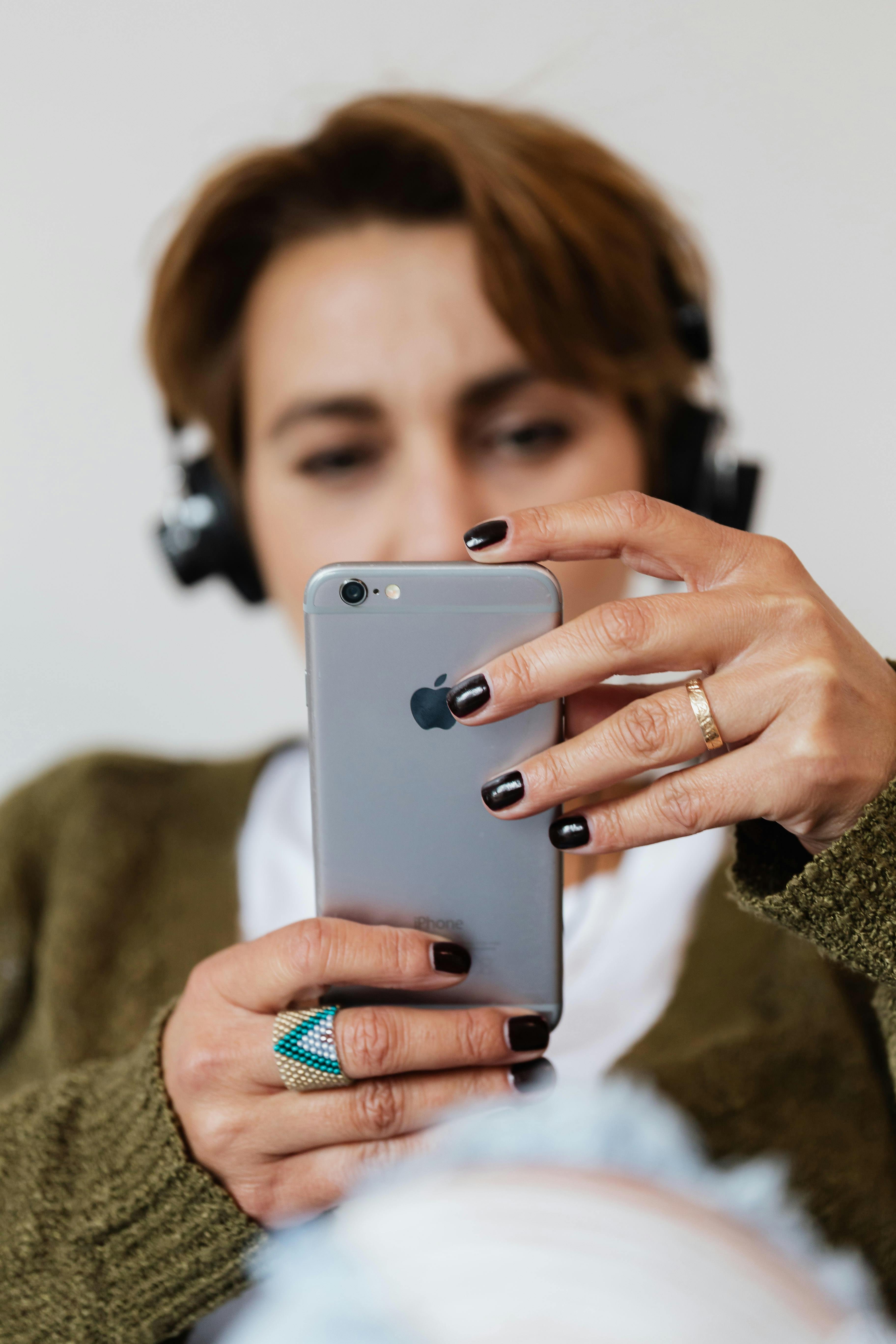 Person using smartphone with headphones